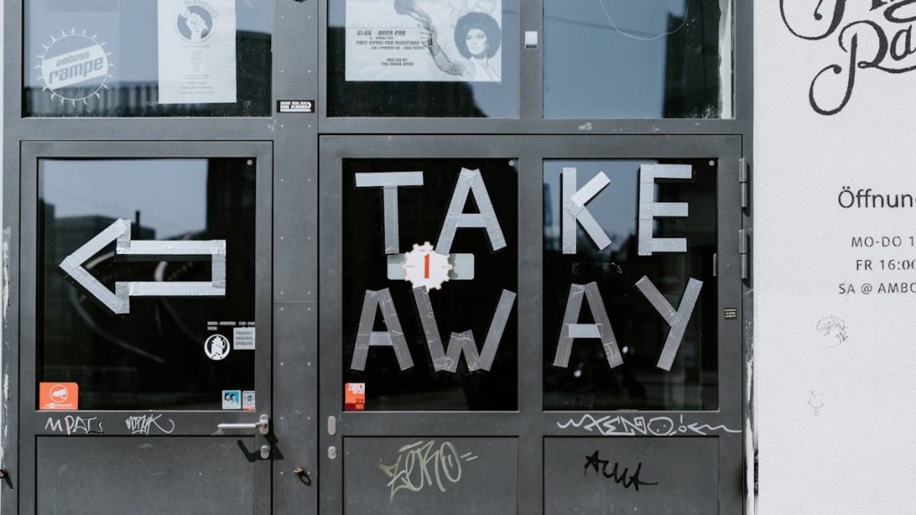 a door with graffiti written on it that says take away