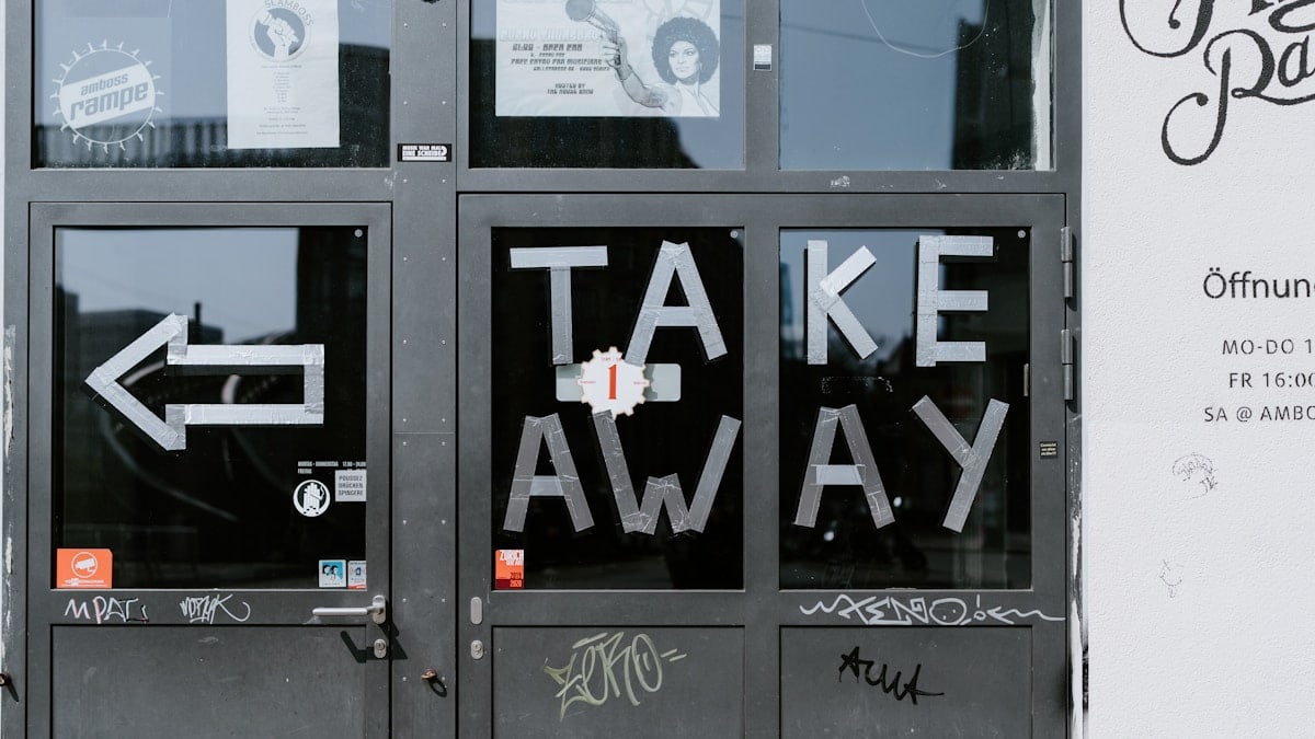 a door with graffiti written on it that says take away